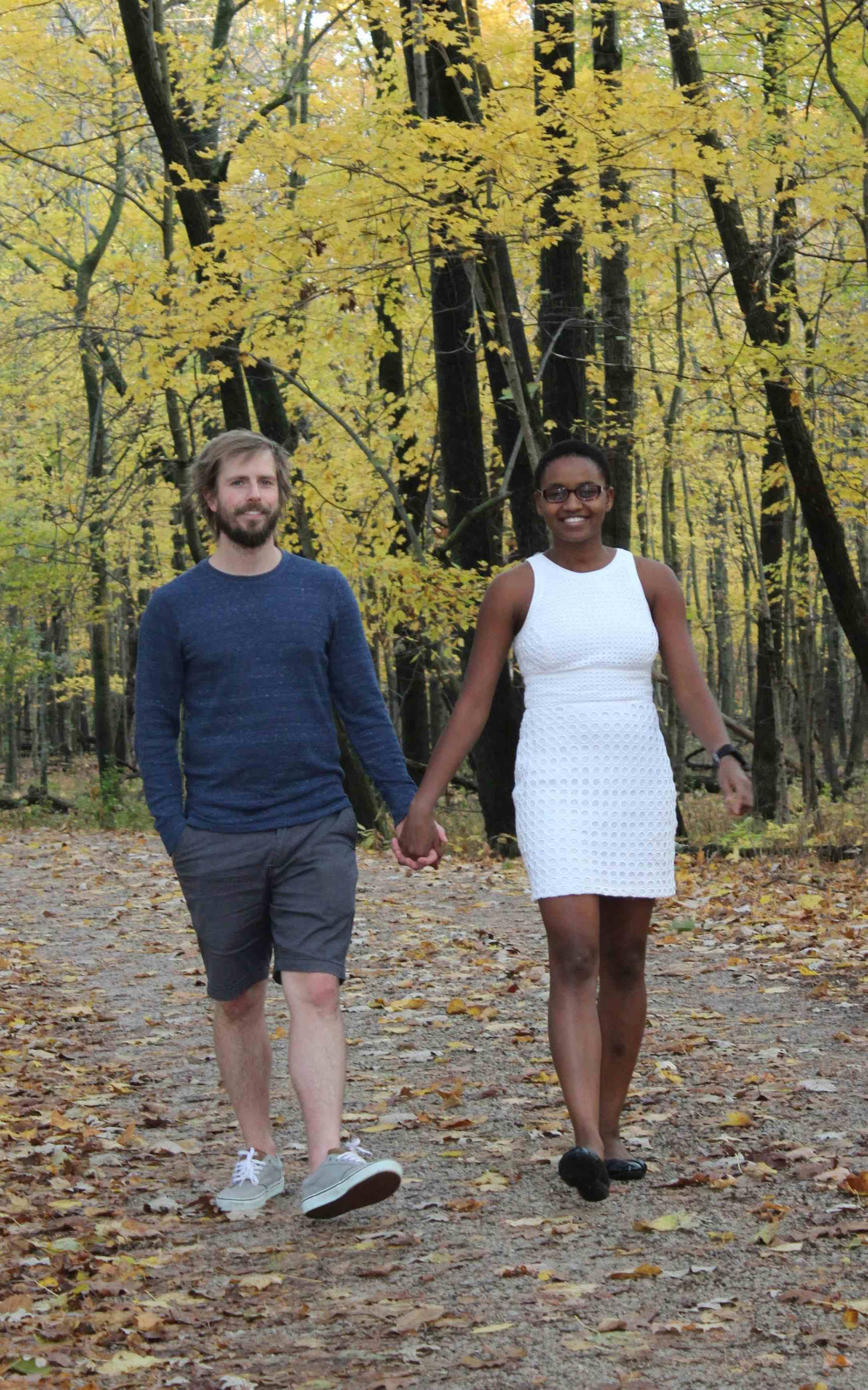 Nelly Cheboi and Tyler Cinnamon walking holding hand at forest preserve shabbona